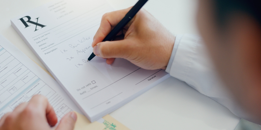 Doctor writing with document for prescription